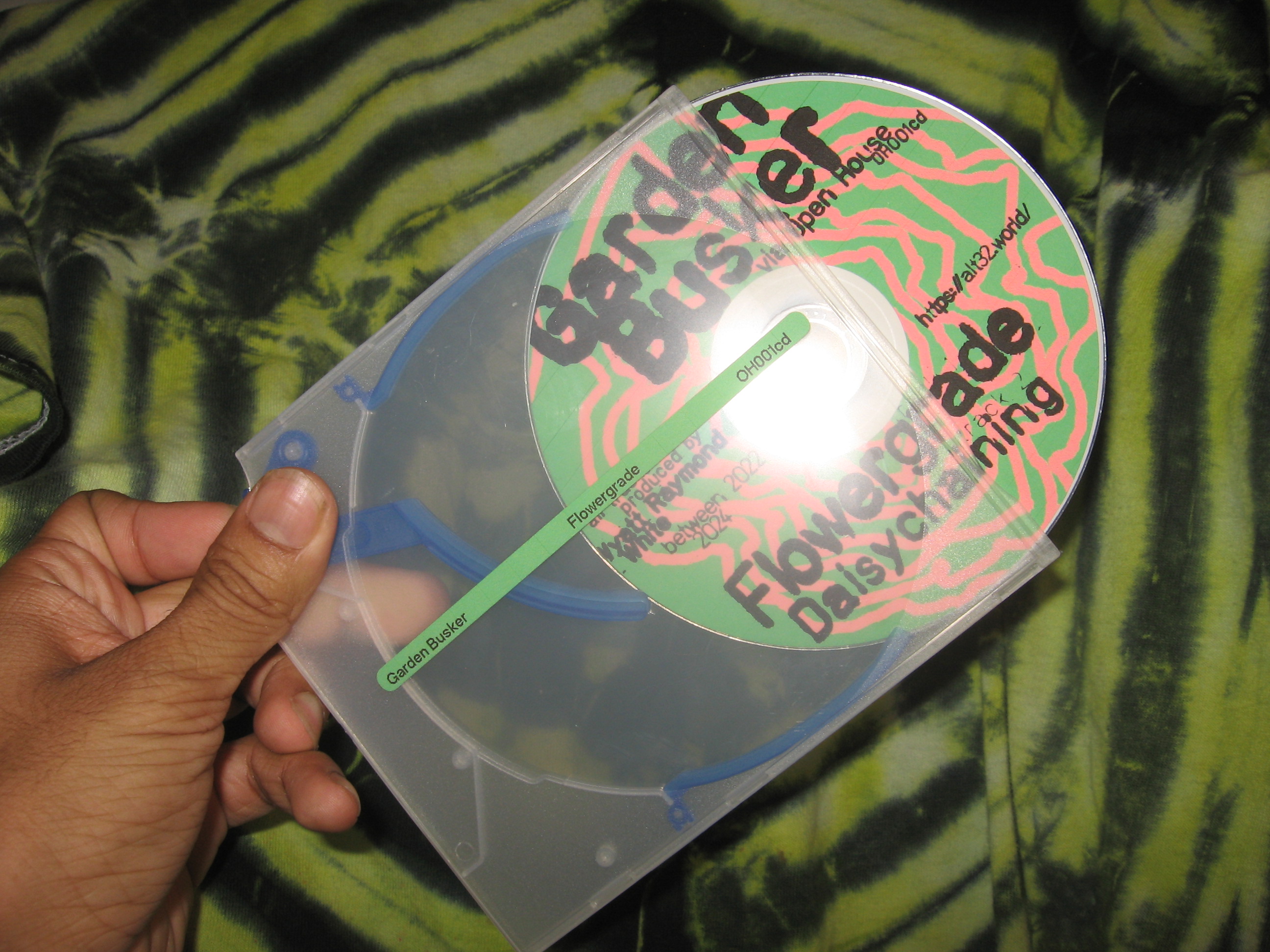 Flash photo of my 'Flowergrade' CD half-ejected out of the case.